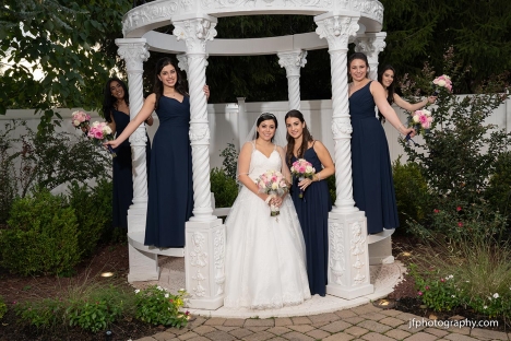 Bride And Bridal Party Outdoor Ceremony Garden